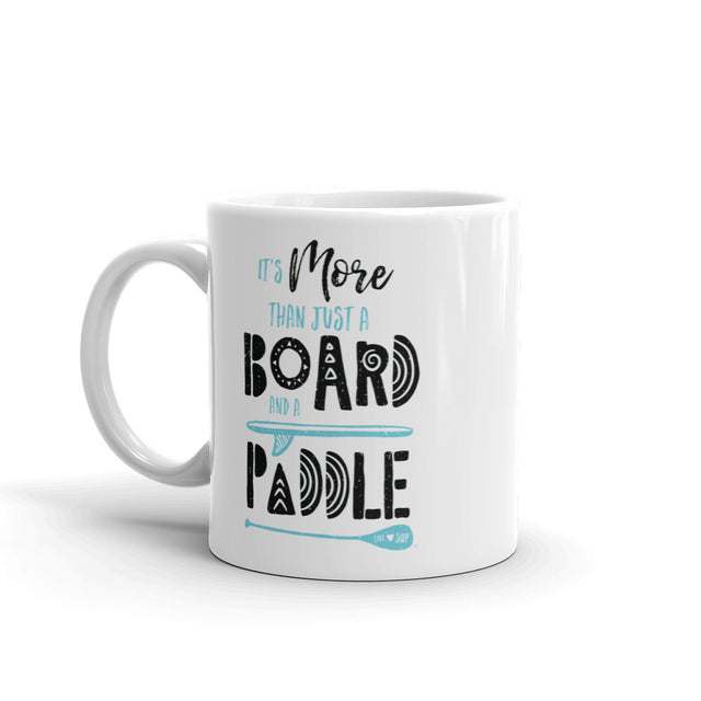 Glossy white ceramic mug featuring a “Board & Paddle” SUP logo printed on both sides; dishwasher and microwave safe perfect for paddleboarding enthusiasts.